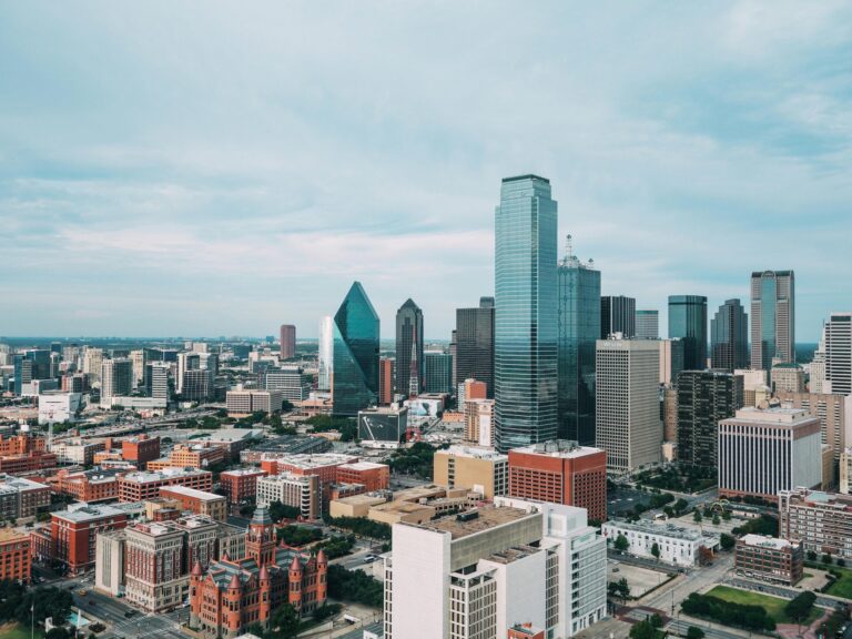 Aerial view of the vibrant Dallas skyline with iconic skyscrapers and urban landscape.